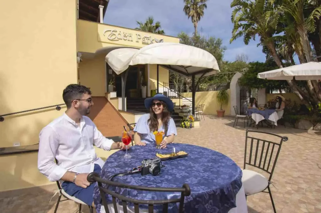 Coppia con un drink al tavolino in giardino